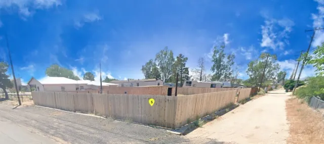 a view of a backyard with wooden fence
