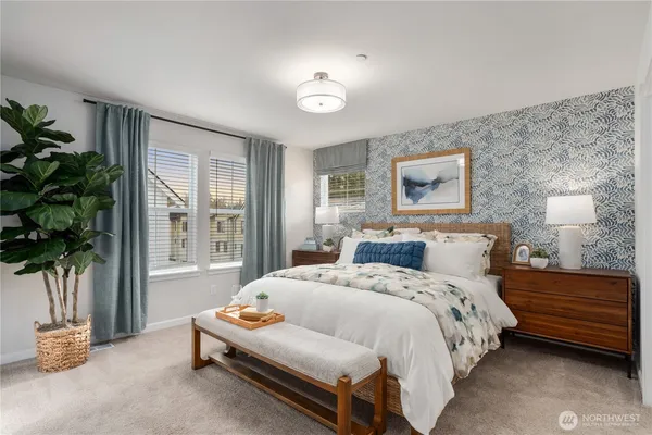 a bedroom with a bed and a potted plant