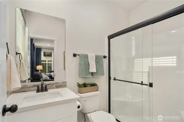 a bathroom with a sink toilet and shower