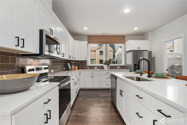 a kitchen with stainless steel appliances granite countertop a sink and cabinets