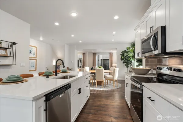 a kitchen with counter space sink appliances and cabinets