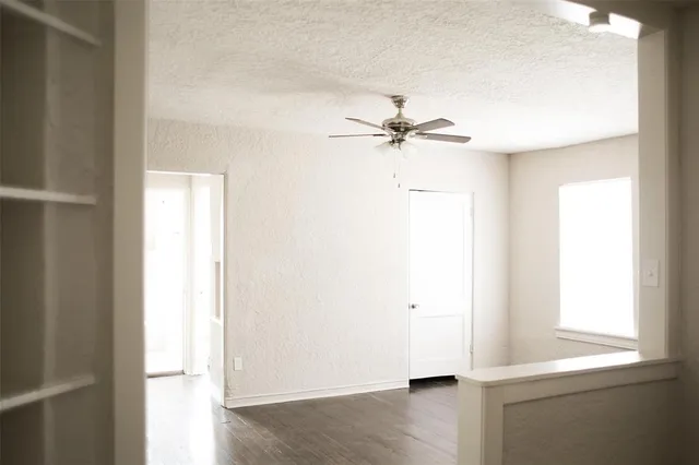 a view of room with a ceiling fan and a window