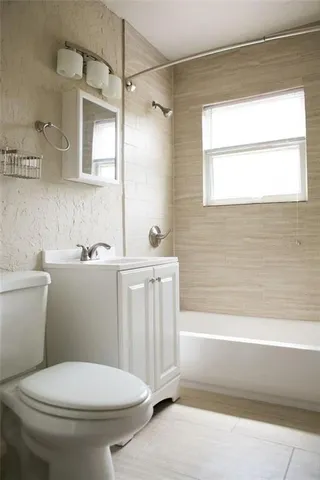 a bathroom with a toilet a sink and a bathtub
