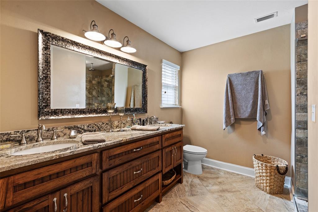 4639 Southwest Wilson Springs Road Fort White, FL 32038 - Photo 12 of 36 a bathroom with a double vanity sink and a mirror