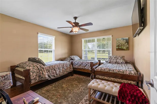 a bedroom with two beds and a large window
