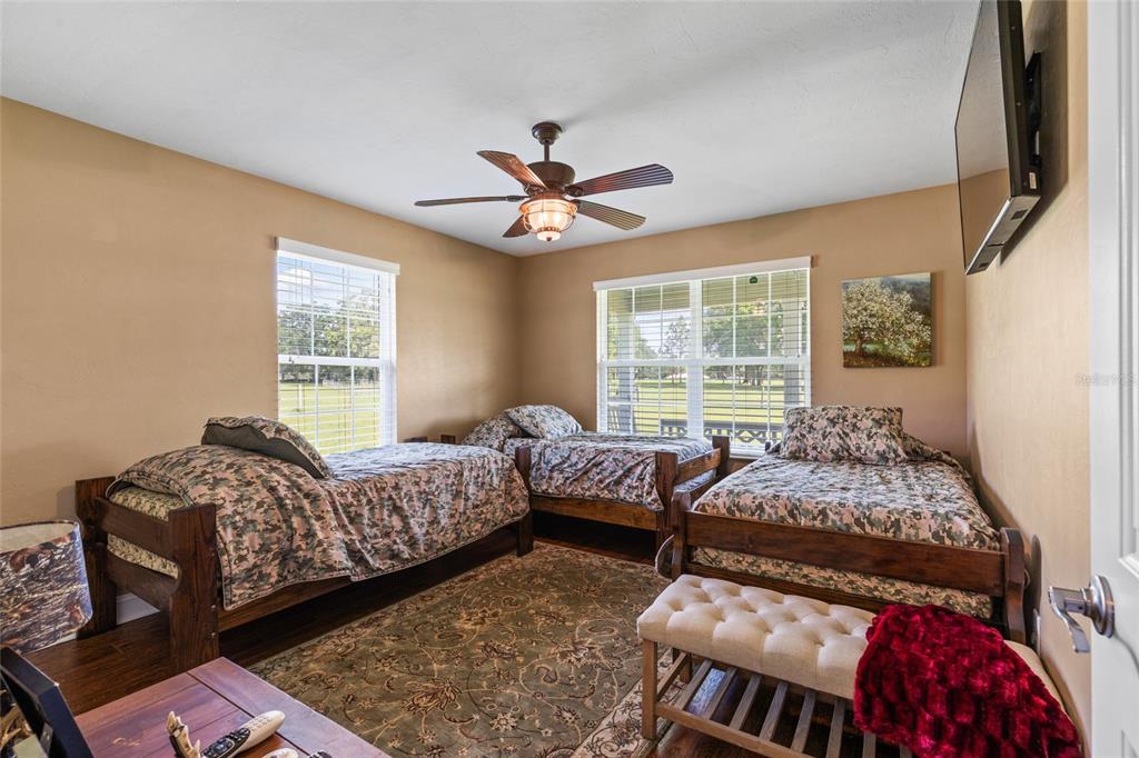 4639 Southwest Wilson Springs Road Fort White, FL 32038 - Photo 14 of 36 a bedroom with two beds and a large window