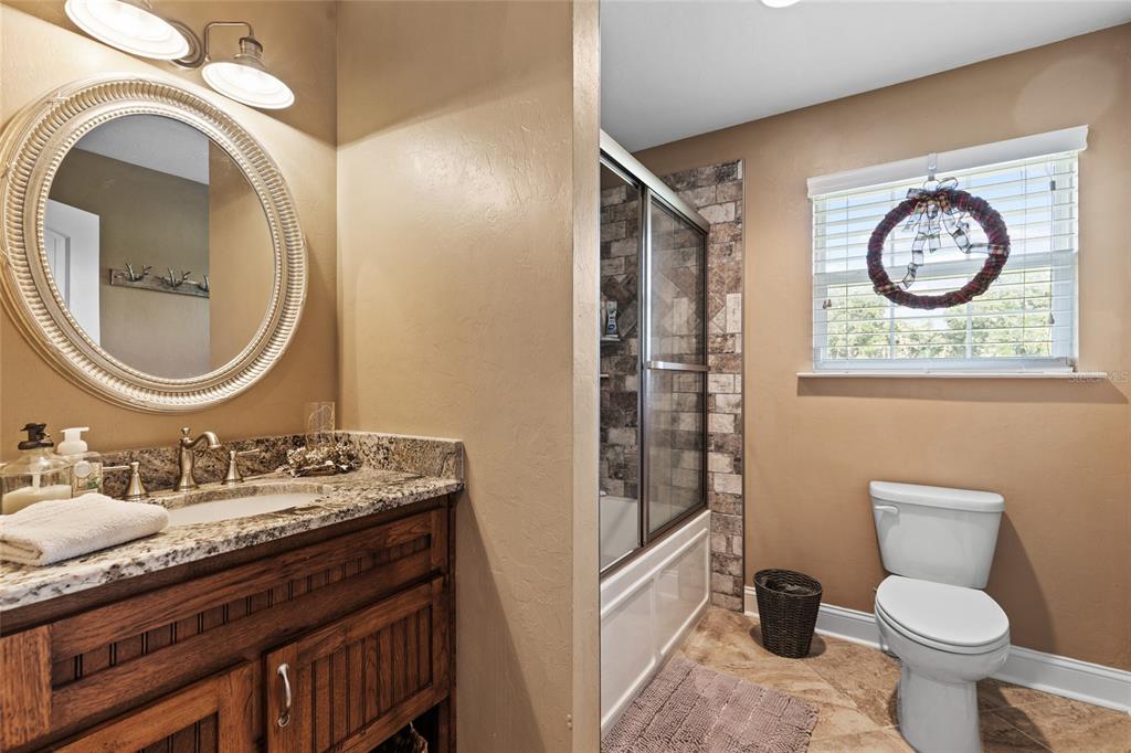 4639 Southwest Wilson Springs Road Fort White, FL 32038 - Photo 15 of 36 a bathroom with a toilet a sink and a mirror