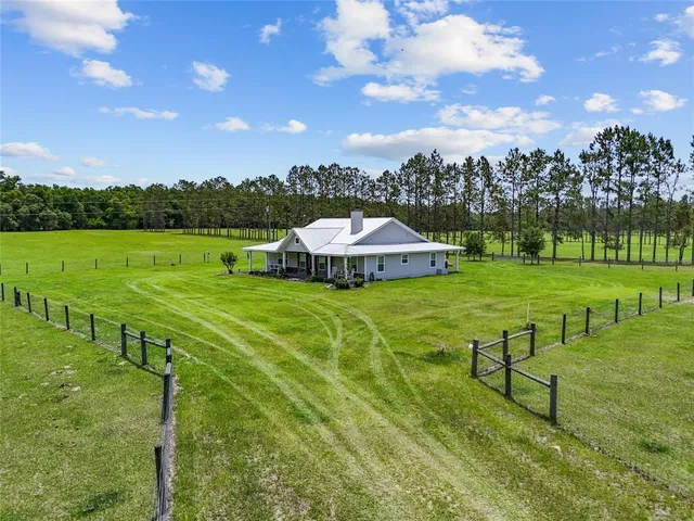 a view of a house with yard and a yard