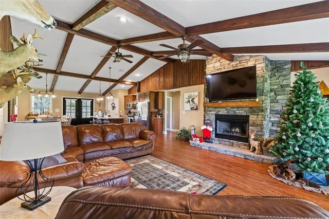 a living room with fireplace furniture and a flat screen tv