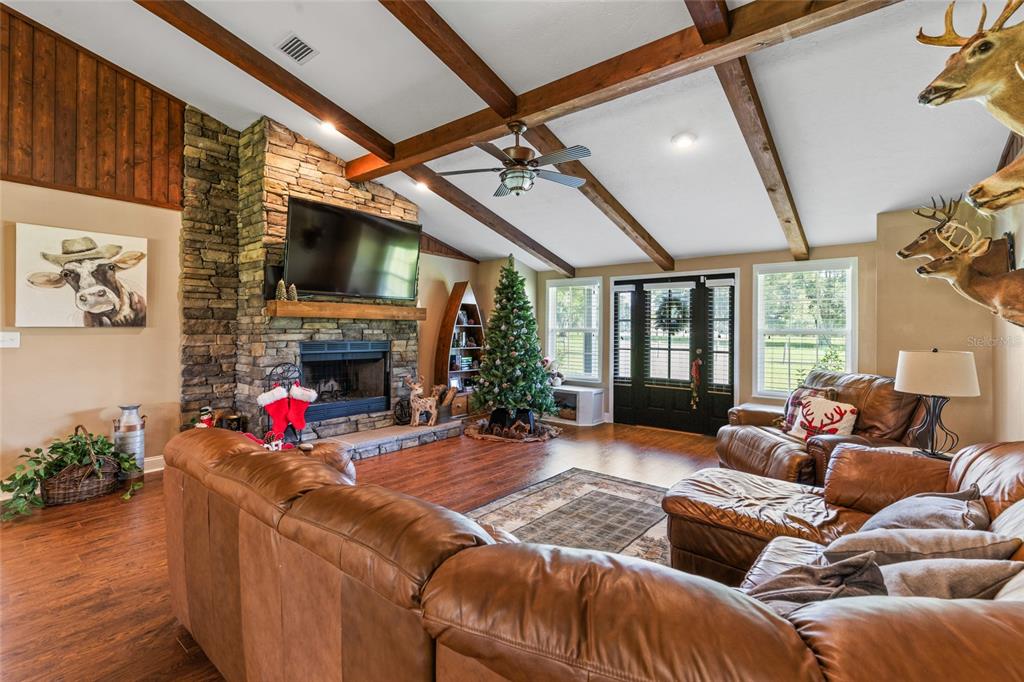 4639 Southwest Wilson Springs Road Fort White, FL 32038 - Photo 7 of 36 a living room with furniture a fireplace and a flat screen tv