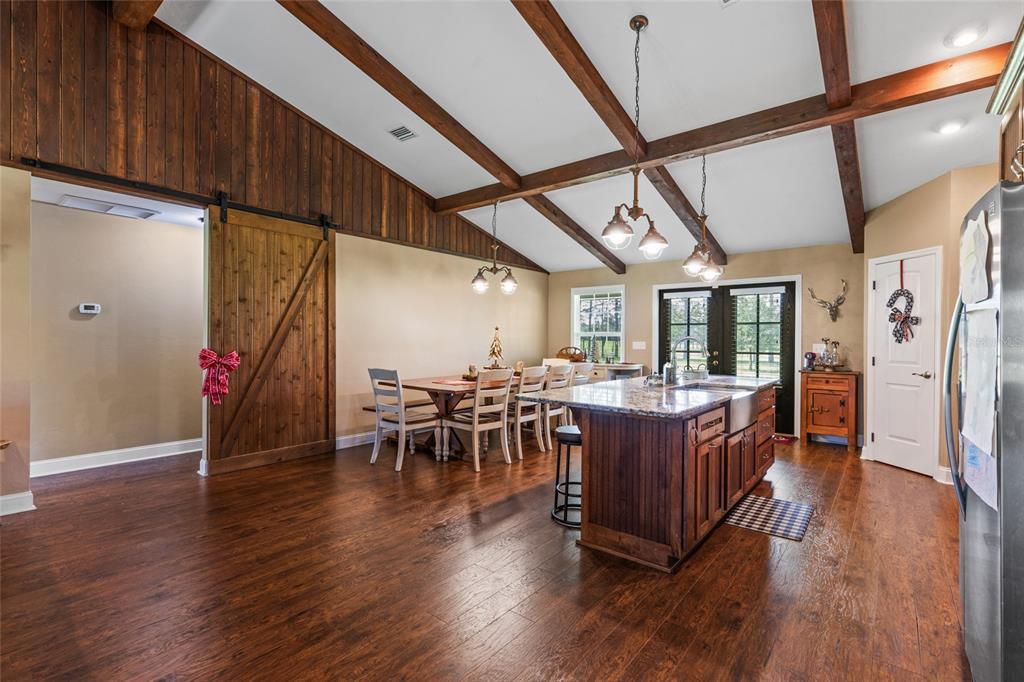 4639 Southwest Wilson Springs Road Fort White, FL 32038 - Photo 8 of 36 a view of a dining room with furniture window and wooden floor