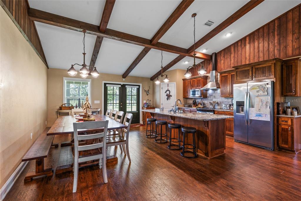 4639 Southwest Wilson Springs Road Fort White, FL 32038 - Photo 9 of 36 a view of a dining room with furniture window and wooden floor