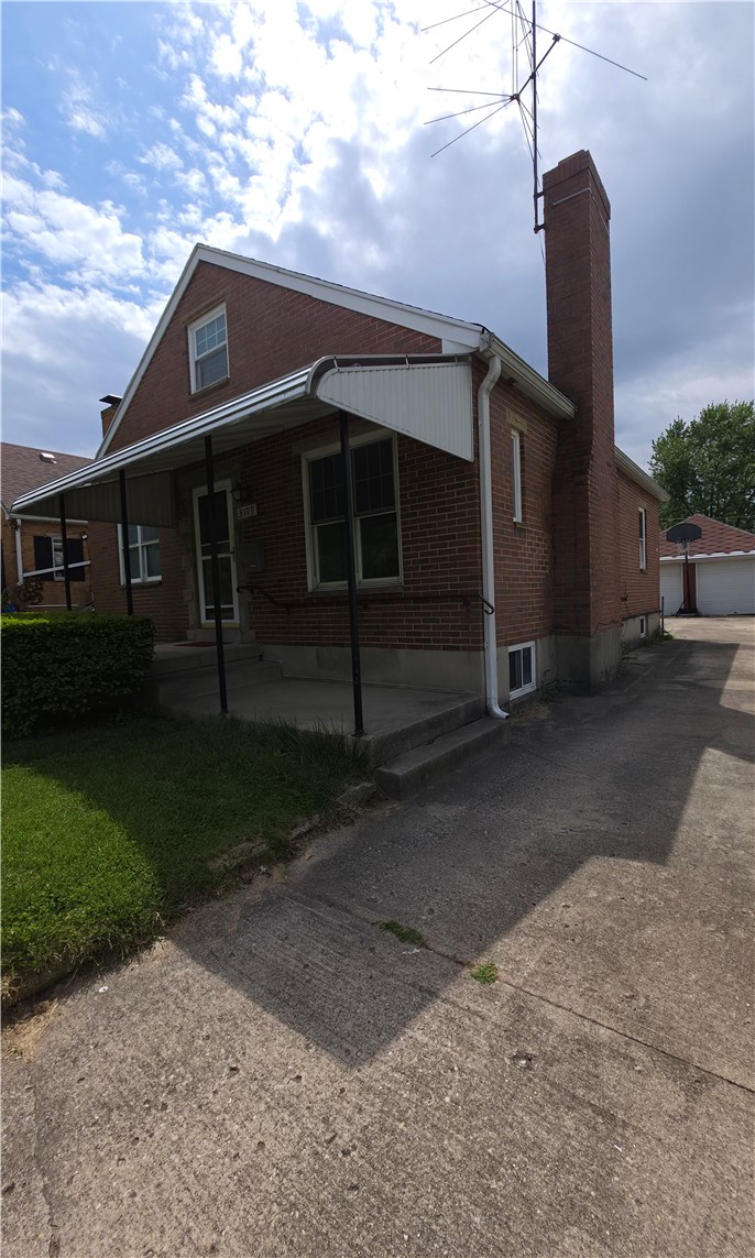 3109 Shroyer Road Kettering, OH 45429 - Photo 23 of 25 This brick residence features a covered porch, offering a welcoming entrance and ample outdoor living space.