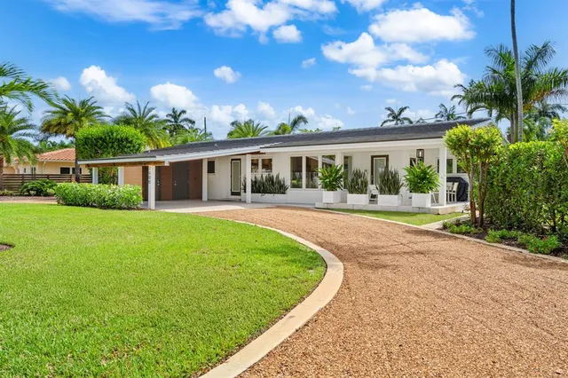a view of a house with a backyard porch and sitting area