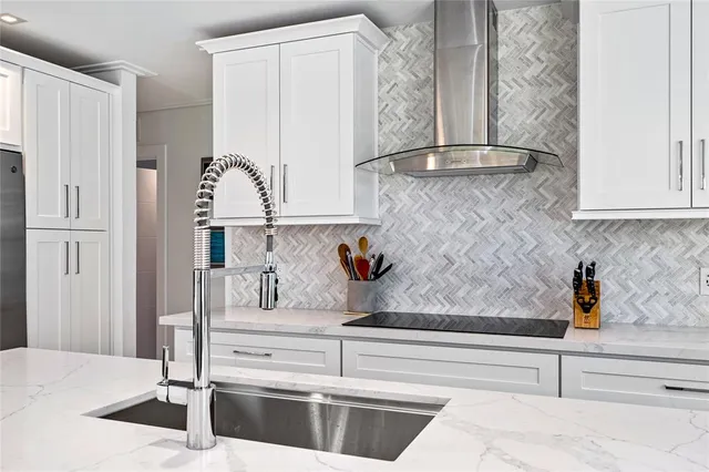 a kitchen with a sink and refrigerator