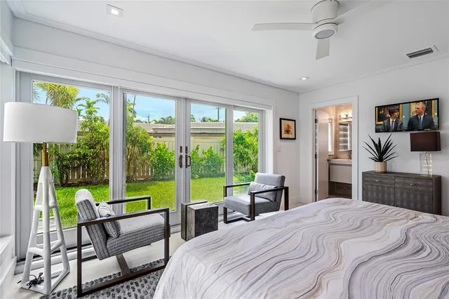 a bedroom with a bed a large window and walk in closet