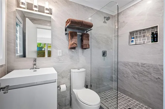 a bathroom with a toilet a sink and shower