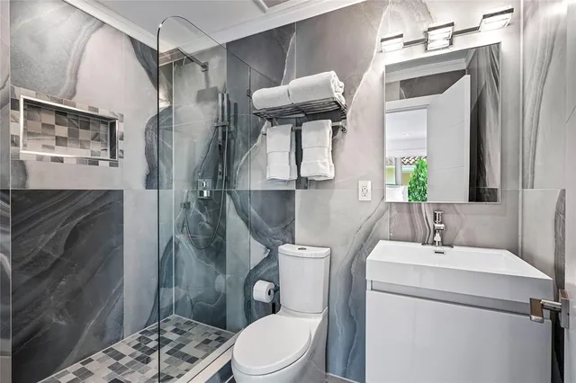 a bathroom with a toilet sink and shower