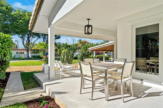 a view of patio with dining table and chairs