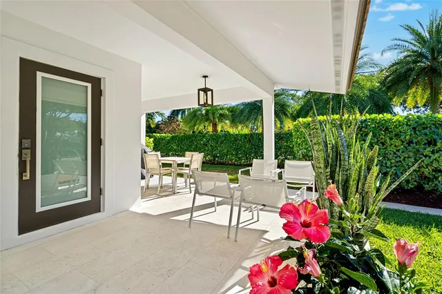 a view of a patio with table and chairs potted plants