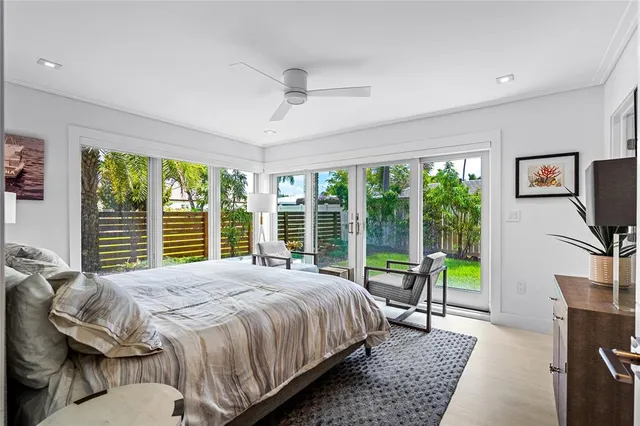a bedroom with a bed a large window and walk in closet