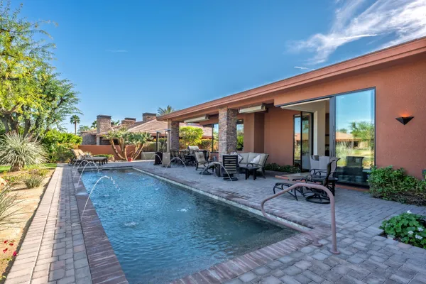 a view of a swimming pool with outdoor seating