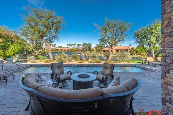 a view of a chairs and table in patio