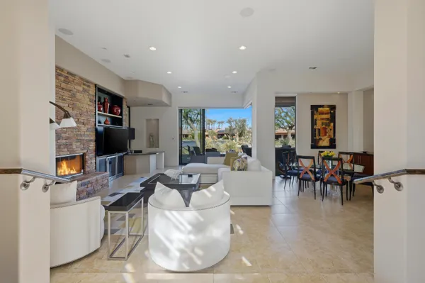 a large kitchen with kitchen island granite countertop a large window and a sink