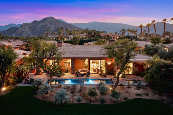 a swimming pool with outdoor seating and yard