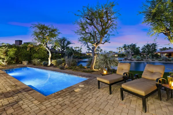 a view of a swimming pool with outdoor seating
