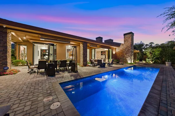 an aerial view of residential houses with outdoor space and swimming pool
