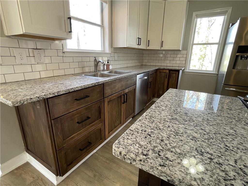 3492 Point View Circle Gainesville, GA 30506 - Photo 17 of 67 a kitchen with stainless steel appliances kitchen island granite countertop a sink window and cabinets