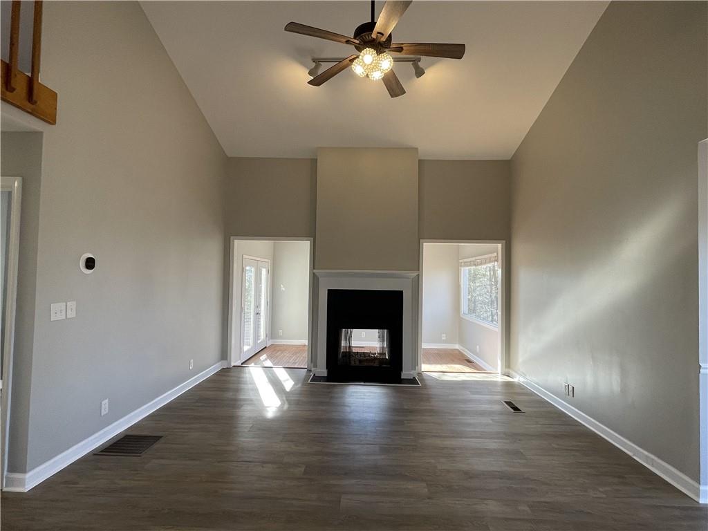 3492 Point View Circle Gainesville, GA 30506 - Photo 18 of 67 a view of a livingroom with a fireplace a ceiling fan and wooden floor