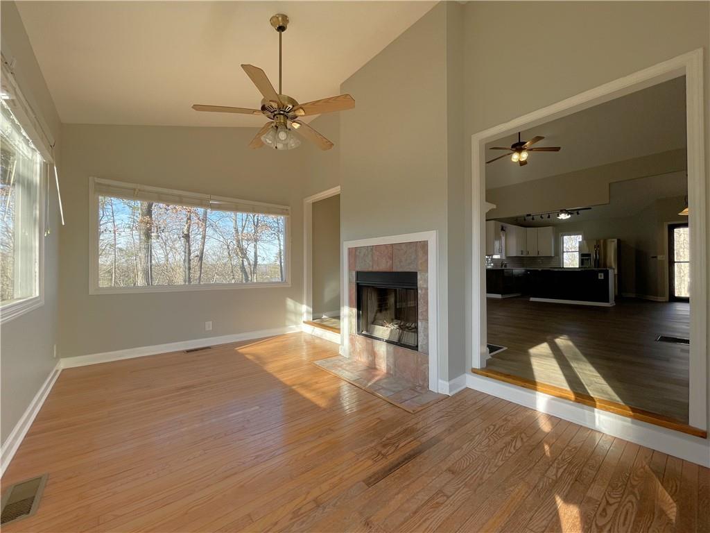 3492 Point View Circle Gainesville, GA 30506 - Photo 23 of 67 a view of a livingroom with wooden floor a ceiling fan and windows