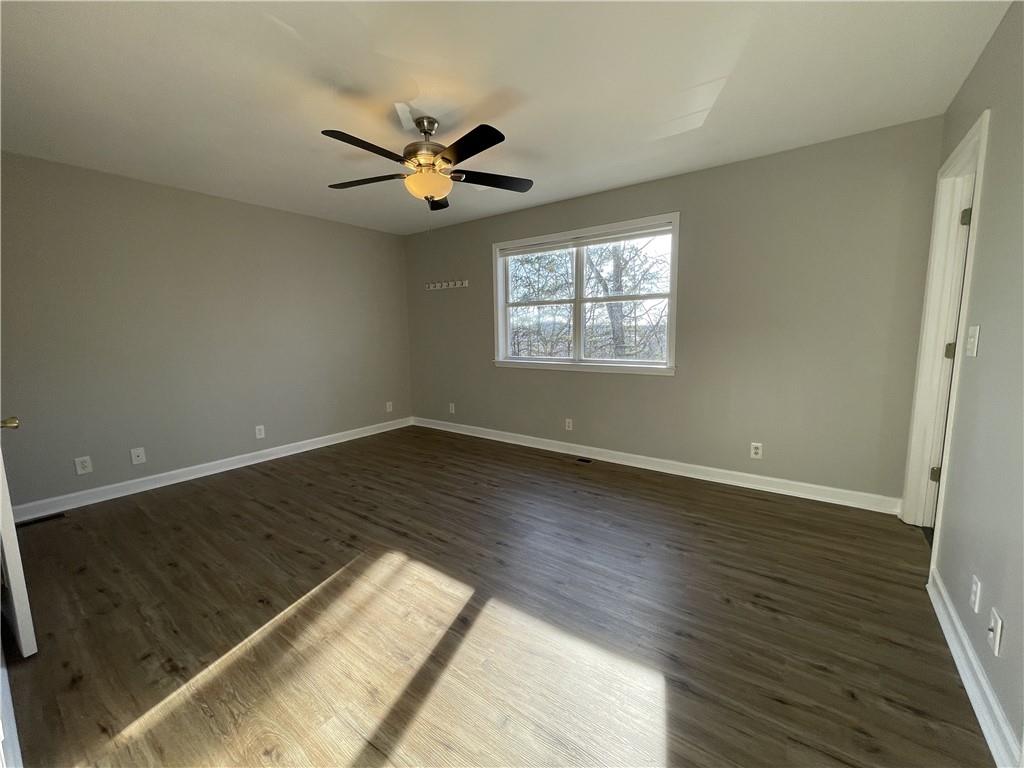 3492 Point View Circle Gainesville, GA 30506 - Photo 28 of 67 an empty room with wooden floor fan and windows