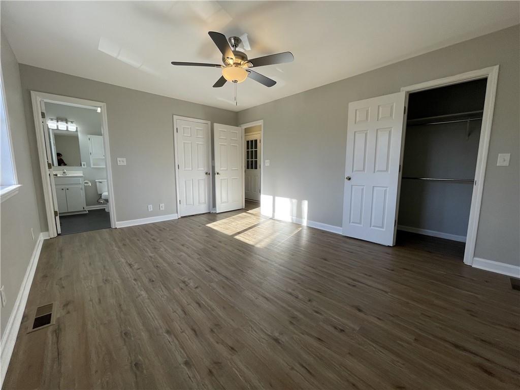 3492 Point View Circle Gainesville, GA 30506 - Photo 30 of 67 a view of a livingroom with wooden floor and a ceiling fan