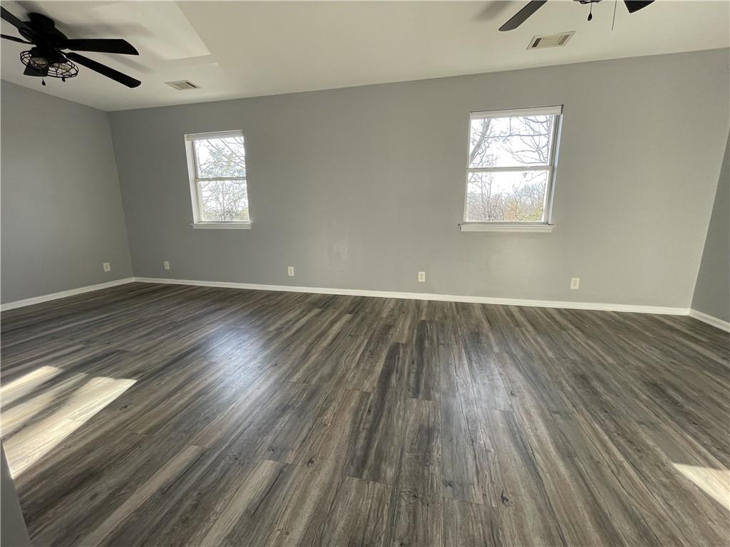 3492 Point View Circle Gainesville, GA 30506 - Photo 36 of 67 an empty room with wooden floor chandelier fan and windows
