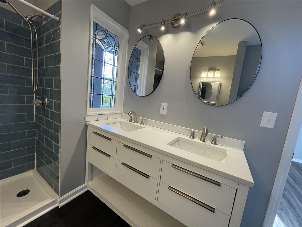 3492 Point View Circle Gainesville, GA 30506 - Photo 42 of 67 a bathroom with a double vanity sink mirror and shower