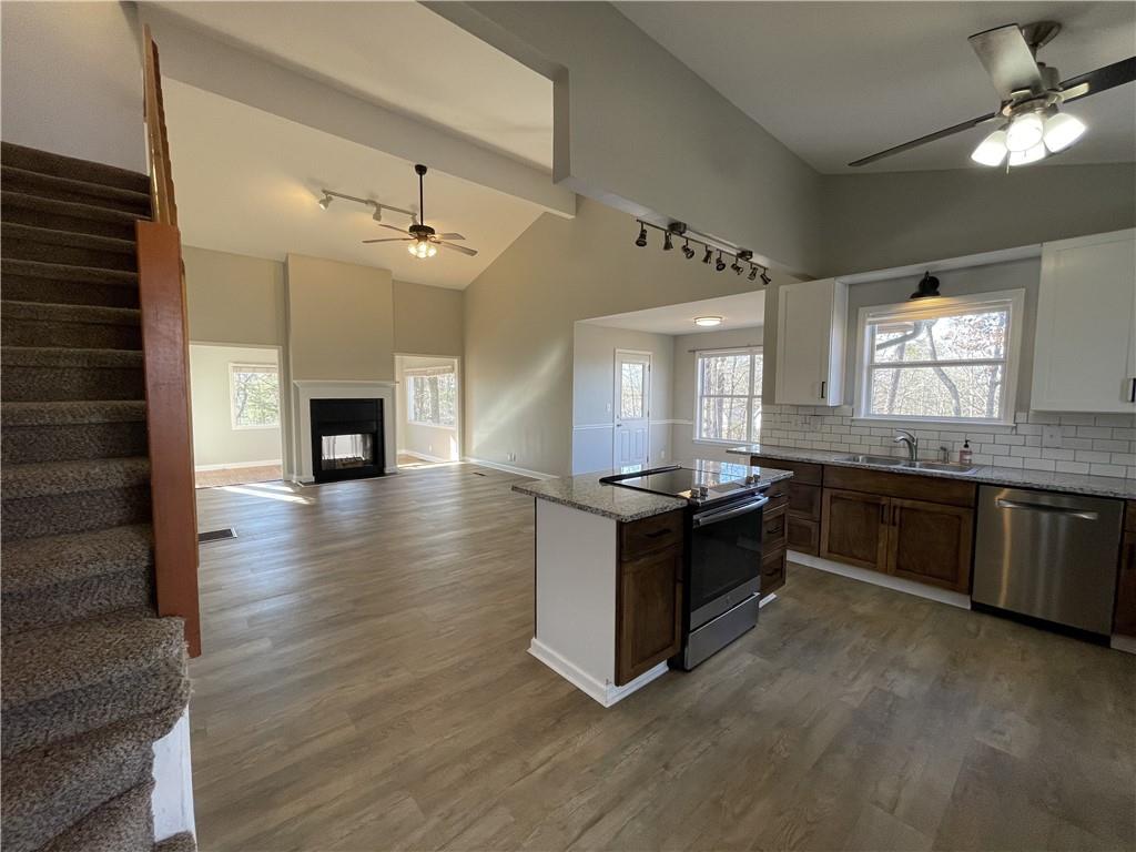 3492 Point View Circle Gainesville, GA 30506 - Photo 9 of 67 a kitchen with granite countertop a stove and a wooden floors