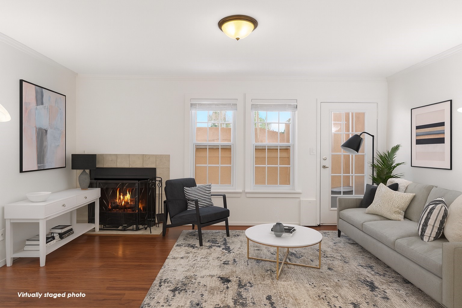 Virtually staged photo for inspo - The living area opens up to a covered balcony, extending your living space outdoors.