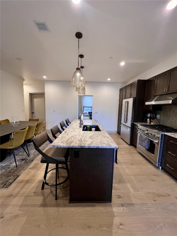 52 6th Street, Unit A4 Silverthorne, CO 80498 - Photo 6 of 15 a large kitchen with kitchen island a sink table and chairs