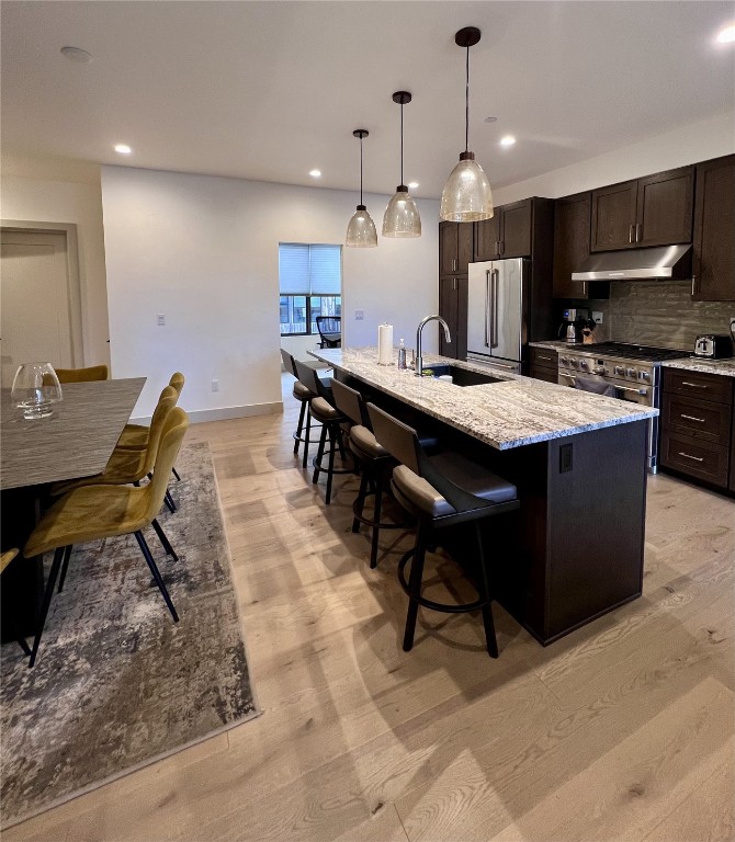 52 6th Street, Unit A4 Silverthorne, CO 80498 - Photo 7 of 15 a kitchen with granite countertop a table chairs sink and cabinets