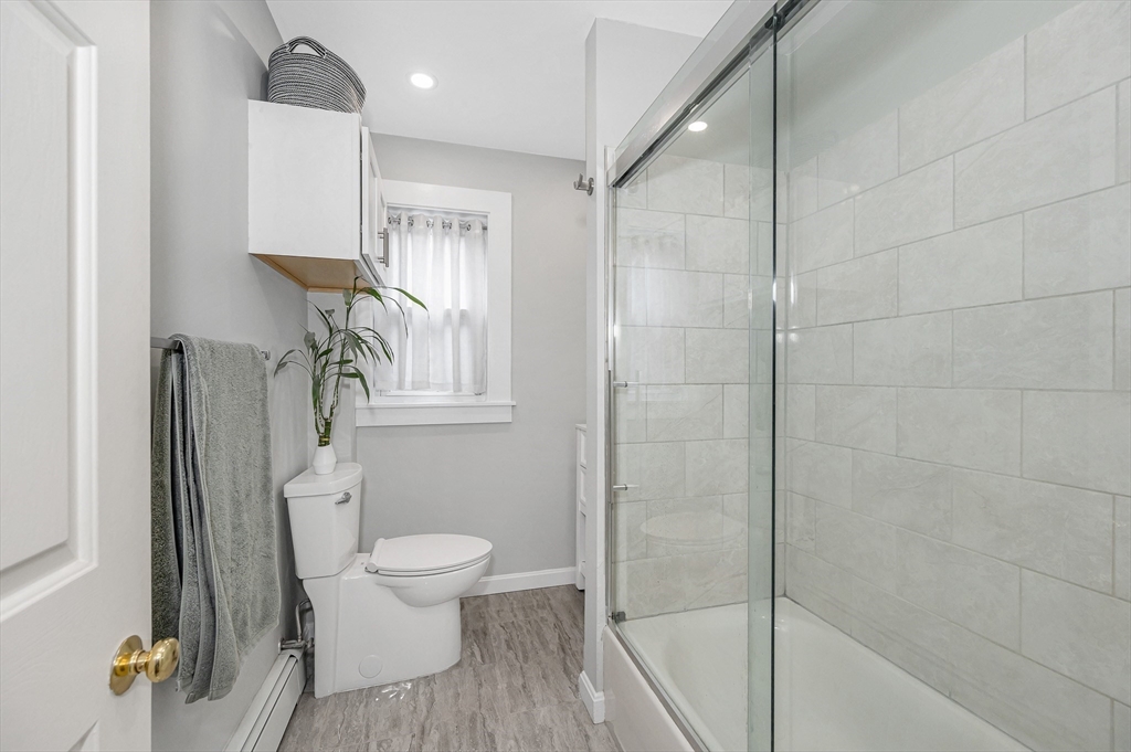 499 Humphrey Street, Unit 3 Swampscott, MA 01907 - Photo 12 of 27 a bathroom with a sink a toilet and shower