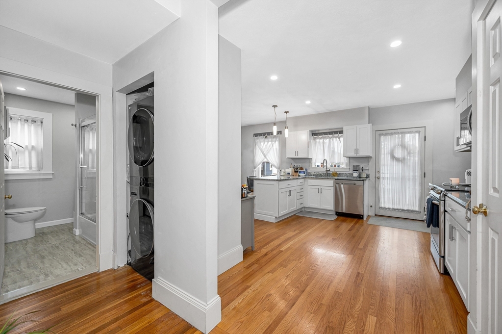 499 Humphrey Street, Unit 3 Swampscott, MA 01907 - Photo 15 of 27 a view of a kitchen with wooden floor and a sink