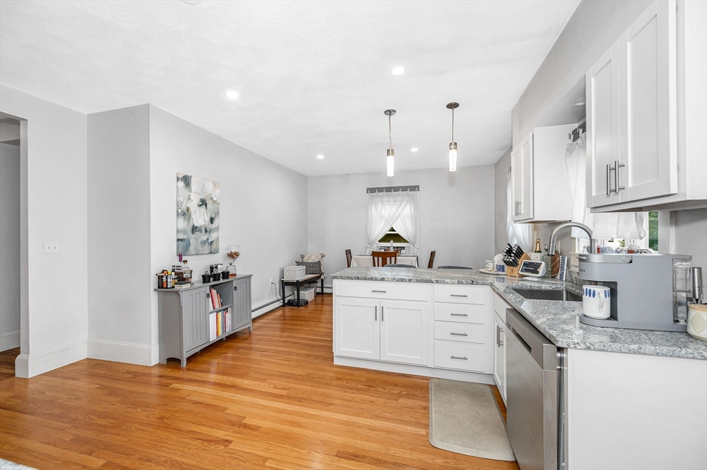 499 Humphrey Street, Unit 3 Swampscott, MA 01907 - Photo 18 of 27 a kitchen with a sink stove and cabinets