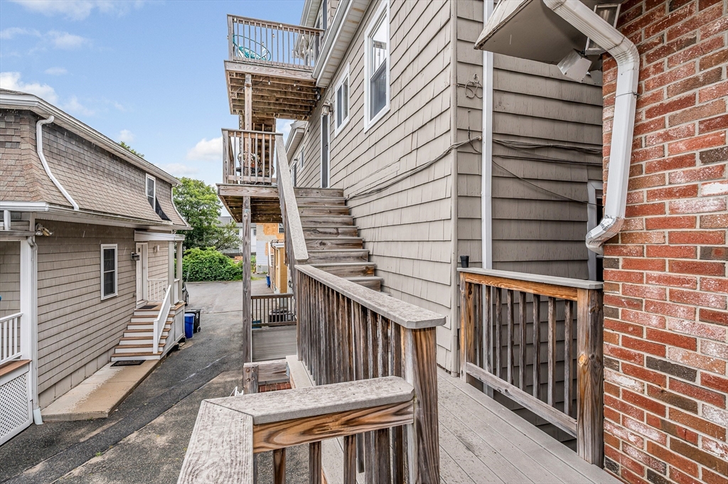 499 Humphrey Street, Unit 3 Swampscott, MA 01907 - Photo 22 of 27 a view of a deck with wooden floor and fence