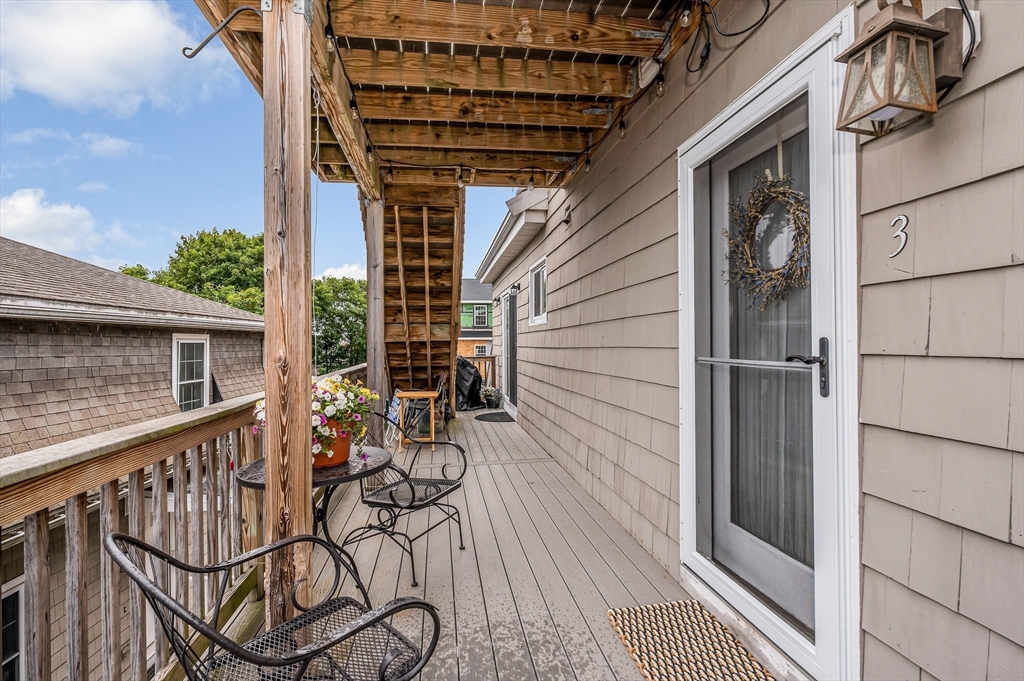 499 Humphrey Street, Unit 3 Swampscott, MA 01907 - Photo 3 of 27 a view of a balcony with chairs