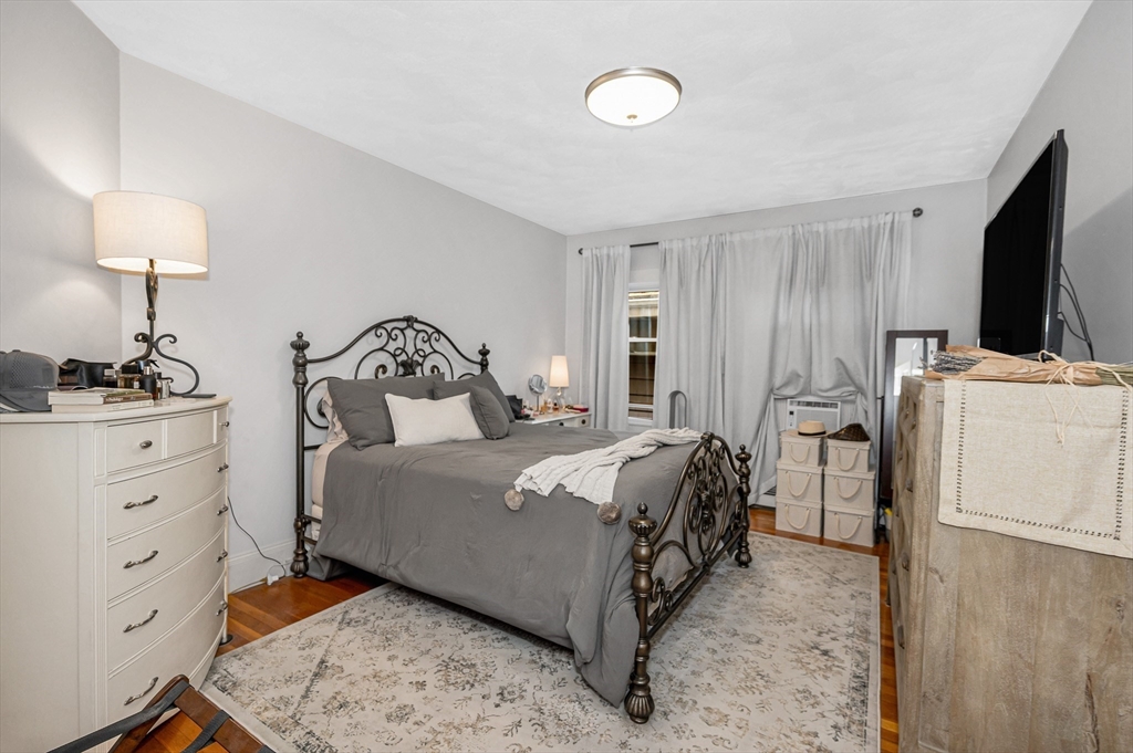 499 Humphrey Street, Unit 3 Swampscott, MA 01907 - Photo 8 of 27 a bedroom with a bed and a flat screen tv