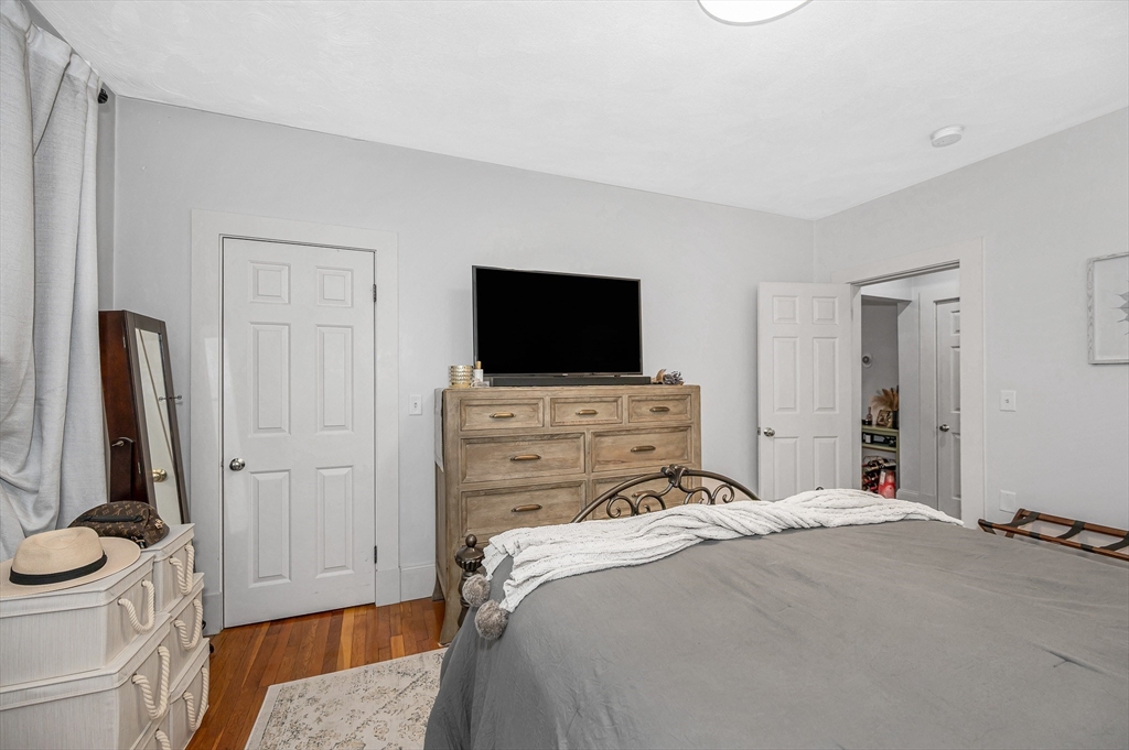 499 Humphrey Street, Unit 3 Swampscott, MA 01907 - Photo 10 of 27 a bedroom with a bed and a flat screen tv