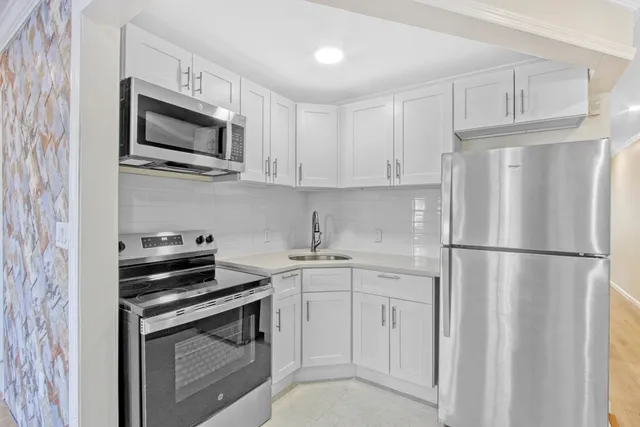 a kitchen with a refrigerator and countertop